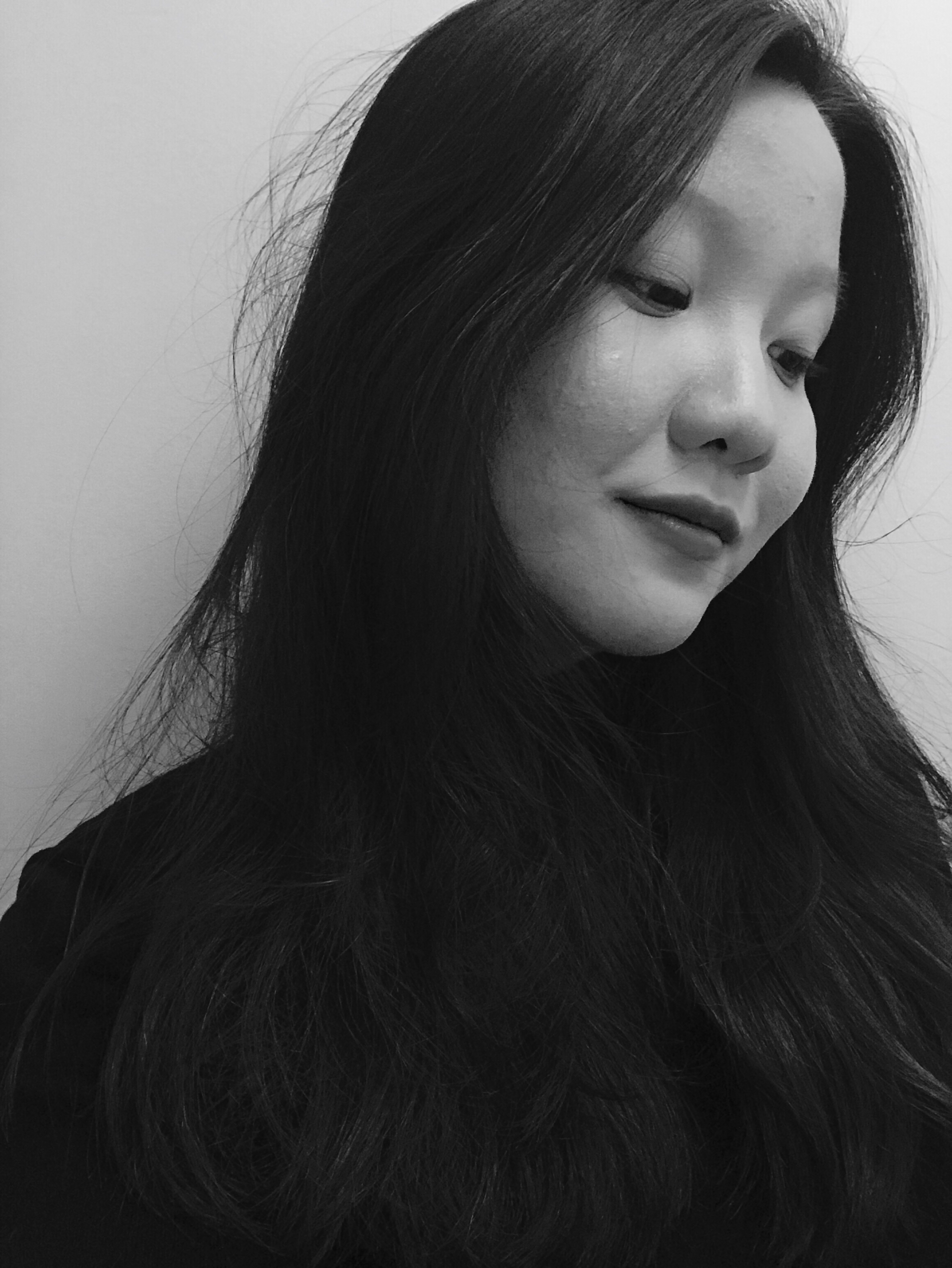 Sandra in a still black-and-white portrait, looking down and to the right.